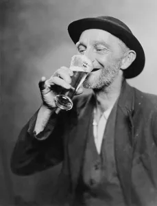 Catalog Images Prints: Happy old man drinking glass of beer, with his daintier finger extended. 1937