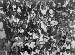 Heavyweights Prints: Harlem crowd celebrating African American boxer