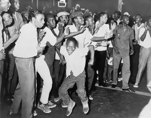 Riots Prints: On Harlem's Lenox Avenue young African Americans chant and taunt New York City police during the riot of July 15-16