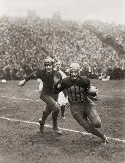Spectators Prints: Harold Red Grange carrying football in Illinois-Michigan game, 1925 (BSLOC_2020_2_189)