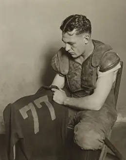 Grange Prints: Harold Red Grange holding his football jersey number