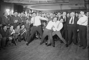 Benny Prints: Harry Houdini cannot escape the hold of boxer Benny Leonard and Jack Dempsey prepare to swing