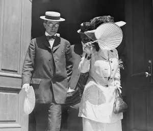 Trial Prints: Harry Thaw (1871-1947), leaving court with a woman (possibly wife Evelyn Nesbit Thaw) covering her face with her fan