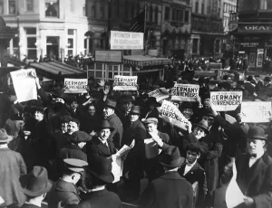 Newspapers Prints: Headlines can be wrong. A crowd at Times Square holding up headlines reading Germany Surrenders
