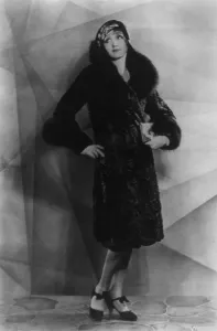 August Prints: Hedda Hopper (1890-1966), as a young actress, modeling a fur coat. 1929