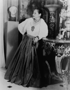Sophisticated Prints: Helena Rubinstein 1870-1965 Polish born cosmetics entrepreneur wearing dramatic jewelry in the dining room of her New