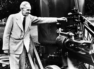 Machinery Prints: Henry Ford marking his 78th birthday by toying with an early steam threshing machine on the Michigan farm where he used