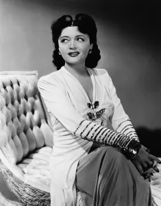 Negri Prints: HI DIDDLE DIDDLE, Pola Negri, in an Adrian gown, 1943