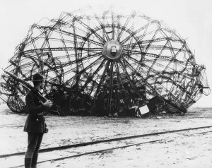 Lcgr1511 Prints: Hindenburg wreckage guarded by a soldier at the Naval Air Station in Lakehurst