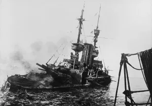 HMS IRRESISTIBLE listing and sinking in the Dardanelles, March 18, 1915. The ship hit a mine while shelling Turkish defenses