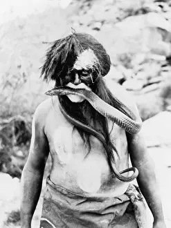 Tribal Cultures Prints: Hopi Indian with painted face and body and snake in mouth. Photo by Ralph Murphy, 1924