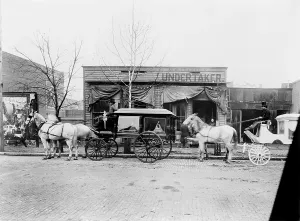 Wheels Prints: Horses and carriages in front of funeral home of C