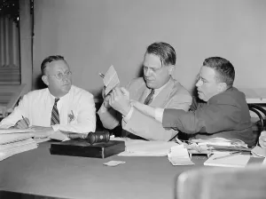 Evidence Prints: HUAC Chairman Martin Dies (center) views communist evidence