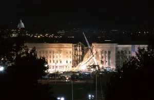 Images Dated 16th March 2011: The huge 20 x 38 feet American flag is to the right of the damaged area of the Pentagon on the night of Sept