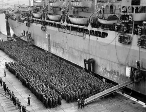Operation Overlord Prints: Hundreds of German POWs, under guard beside an Allied troop ship
