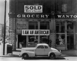 Ethnic Groups Prints: I AM AN AMERICAN sign on a store front