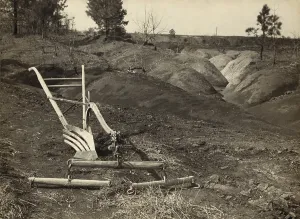 Erosion Prints: An idle plow on farm land adjacent to eroded land in Jackson County Alabama