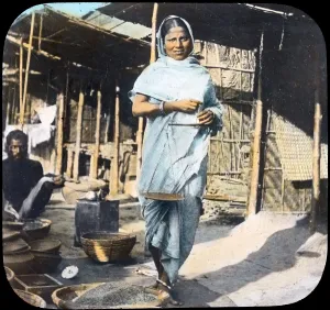 Images Dated 6th March 2008: India, a young woman street vendor holding measuring scales