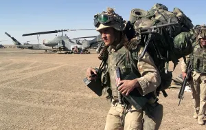 Images Dated 16th March 2011: Infantryman carries a full combat load including a machine gun after seizing a forward operating base during the U
