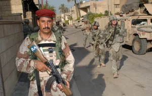 June Prints: An Iraqi soldier leads the way during a search operation with US Army soldiers in the Rusafa area of Baghdad Iraq June