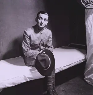Songwriter Prints: Irving Berlin (1888-1989) in WWI army uniform and seated on cot