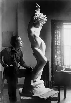 Studios Prints: Isamu Noguchi (1904-1988) standing by his sculpture of a nude woman in 1927