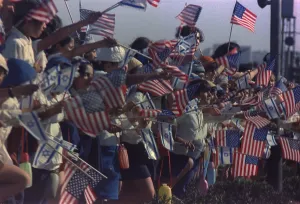 Israel Prints: Israeli children waving American flags line the route of the Presidential motorcade