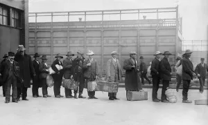 Luggage Prints: Italian men await admission processing at Ellis island