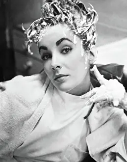 July Prints: IVANHOE, Elizabeth Taylor having a shampoo in makeup on set, 1952