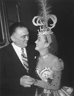 J. Edgar Hoover and actress Dorothy Lamour, looking into each others eyes. She is in costume on the set The Greatest Show on Earth in 1951