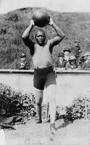 World Champion Prints: Jack Johnson (1878-1946) the first African American to win the Heavyweight Championship training with a medicine ball