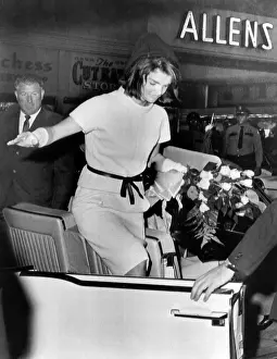 Limousines Prints: Jacqueline Kennedy balances gracefully as she exits a convertible on the day prior to President John Kennedy's