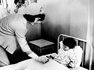 Patient Prints: Jacqueline Kennedy (left), presents a patient at the children's hospital with a flower in Bogota