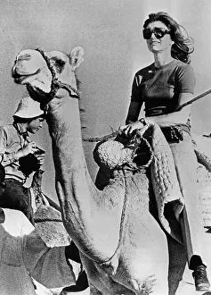 Jacqueline Kennedy Onassis riding a camel while on vacation in Egypt. March 28, 1974. (CSU_ALPHA_885) CSU Archives/Everett Collection