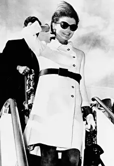 Jacqueline Kennedy, wearing a white coat dress with a short skirt. She deplanes in Rome following a 10-day Asian holiday. Nov. 11, 1967