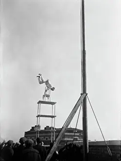 Balancing Act Prints: Jammie Reynolds, balancing on the on chairs on the edge of a rooftop in Washington