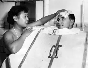 Japanese Prints: A Japanese masseuse applies a cold towel the the head of a GI in a steam bath