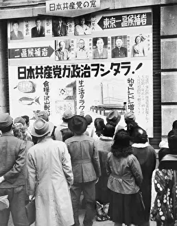 Tokyo Prints: Japanese people read a Communist party election poster outside the Mitsukoshi department store