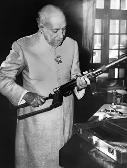 South Asia Prints: Jawaharlal Nehru, Prime Minister of India, holding a machine gun, Dec. 3, 1962