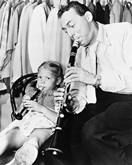 Swing Prints: Jazz musician Woody Herman playing his clarinet while his daughter Ingrid plays a plastic flute