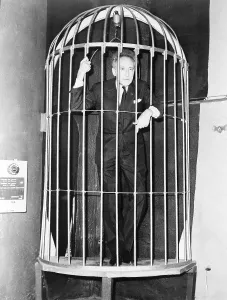 Surrealism Prints: Jean Cocteau (1889-1963), inside a huge bird case during cocktail party he gave in Paris