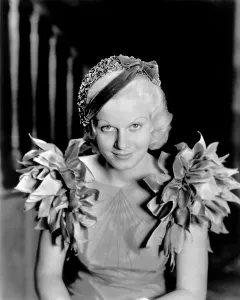 Harlow Prints: Jean Harlow, modeling a blue taffeta frock and velvet hat, 1933