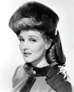 Parker Prints: Jean Parker, modeling a beaver hat with brown silk jersey drapery, 1941