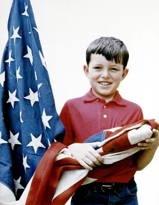 1950s Portrait Prints: Jerry Mathers, showing how to correctly lower and fold an American flag, 1958