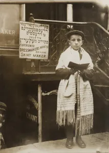 Holidays Prints: Jewish boy wearing a prayer shawl and boy reading from a Hebrew Bible on Yom Kippur