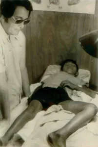 Communes Prints: Jim Jones standing over a Guyanese boy with a near-fatal snake bite