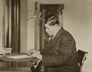 Professional Sports Prints: Jim Thorpe, Gold Medalist of the 1912 Olympics, signing a sheet of paper in early 1913