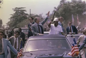 Liberia Prints: Jimmy Carter and President William Tobert 1813-1980 of Liberia wave from their motorcade during the President's