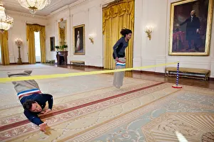 Entertainers Prints: Jimmy Fallon and First Lady Michelle Obama have a potato sack race in the East Room