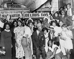 Heavyweights Prints: Joe Louis fans in front of fan headquarters to celebrate Louis close decision victory over Tom Farr